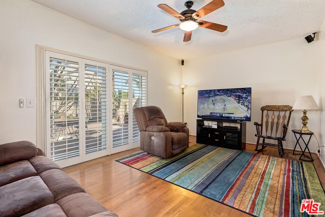 1657 East 218th Street Carson, CA 90745 - Photo 16 of 24 a living room with furniture and a floor to ceiling window