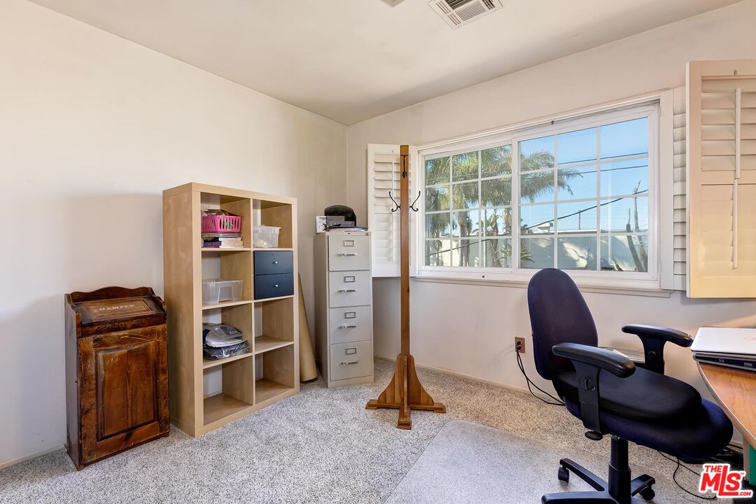 1657 East 218th Street Carson, CA 90745 - Photo 21 of 24 a view of a workspace with furniture and a window