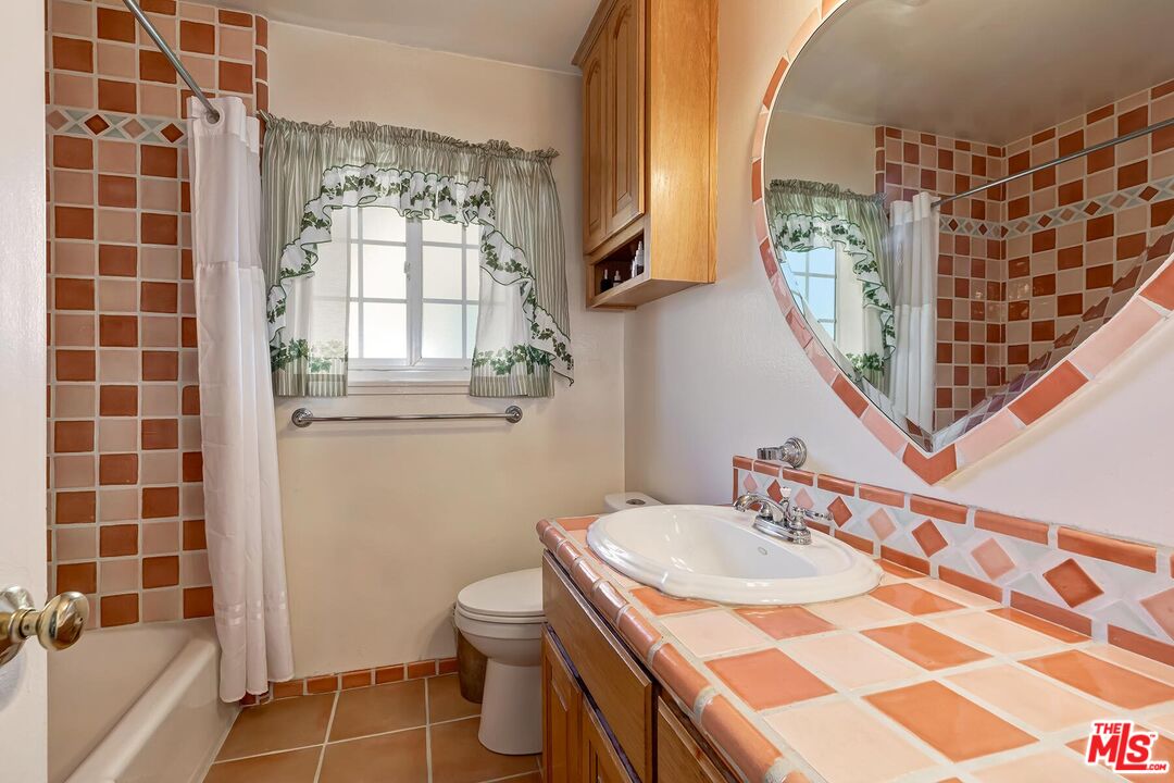 1657 East 218th Street Carson, CA 90745 - Photo 22 of 24 a bathroom with a sink toilet and shower