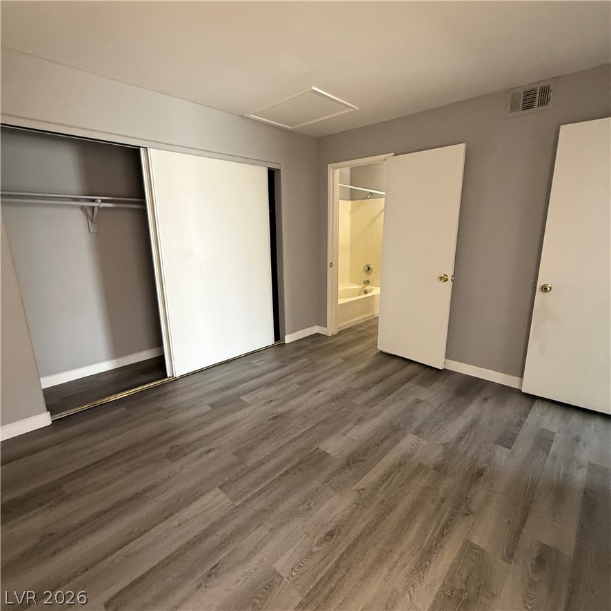 1830 North Pecos Road, Unit 258 Las Vegas, NV 89115 - Photo 8 of 14 Hardwood-style flooring and spacious closets define this inviting bedroom.
