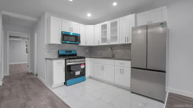 a kitchen with cabinets and stainless steel appliances