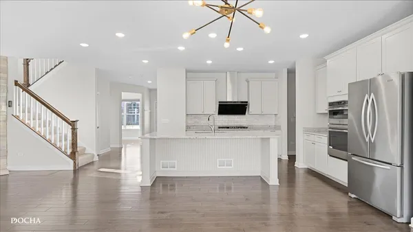 a view of kitchen with microwave stove refrigerator and microwave