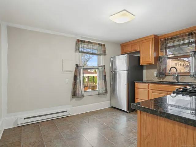 a kitchen with a refrigerator and a sink