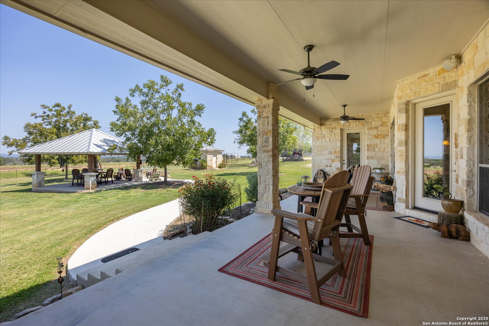 34 Cravey Road Boerne, TX 78006 - Photo 32 of 59 a view of a patio with a table chairs and a yard