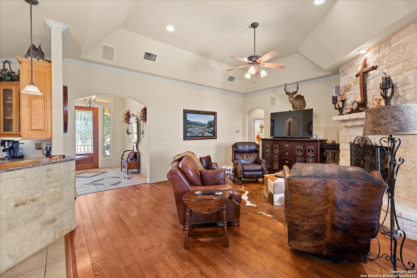 34 Cravey Road Boerne, TX 78006 - Photo 10 of 59 a living room with furniture a fireplace and a chandelier
