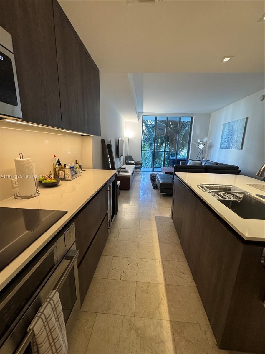 88 Southwest 7th Street, Unit 805 Miami, FL 33130 - Photo 11 of 14 a kitchen with a sink and a stove top oven