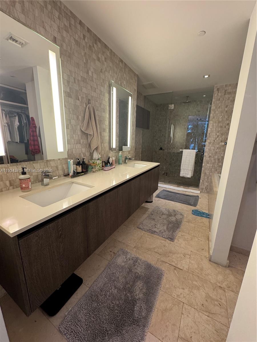 88 Southwest 7th Street, Unit 805 Miami, FL 33130 - Photo 14 of 14 a bathroom with a sink double vanity and a mirror