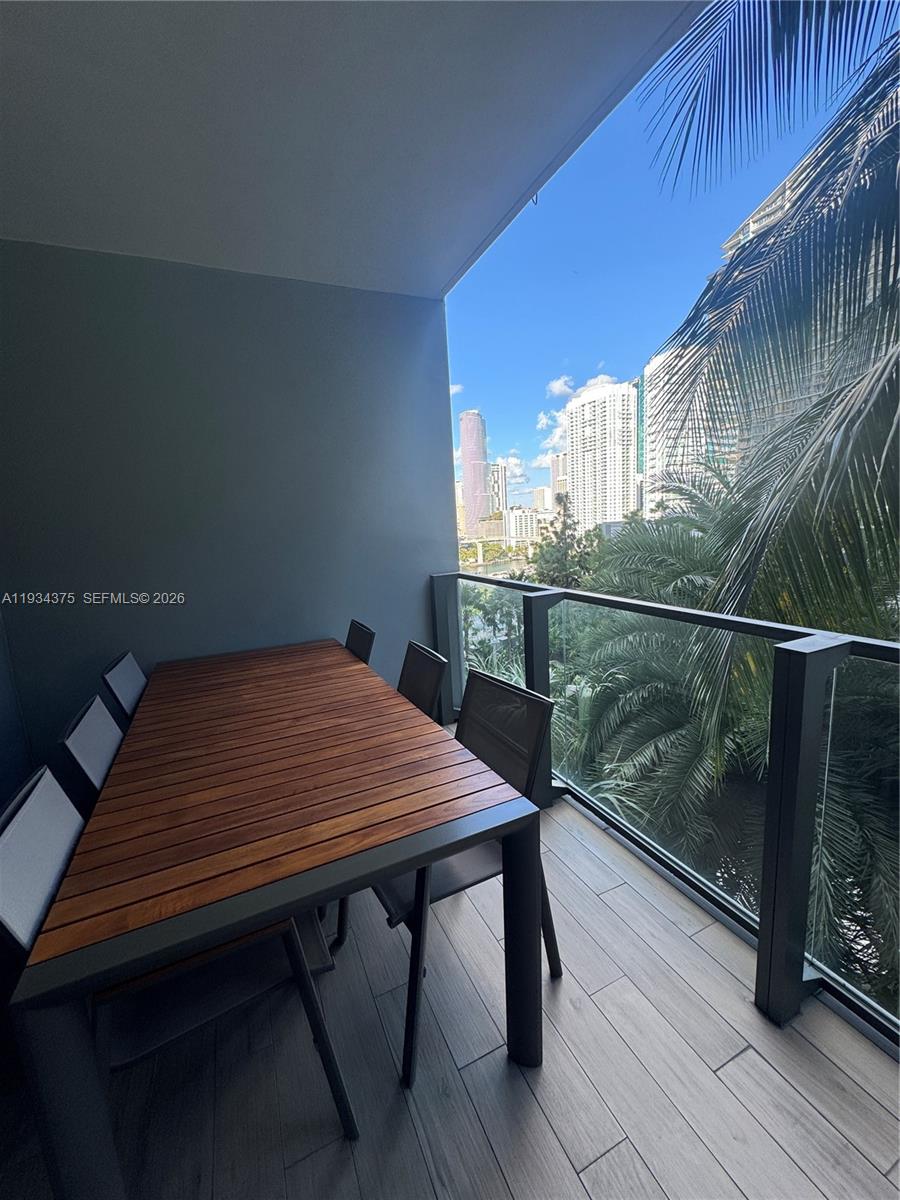 88 Southwest 7th Street, Unit 805 Miami, FL 33130 - Photo 3 of 14 a view of a balcony with table and chairs