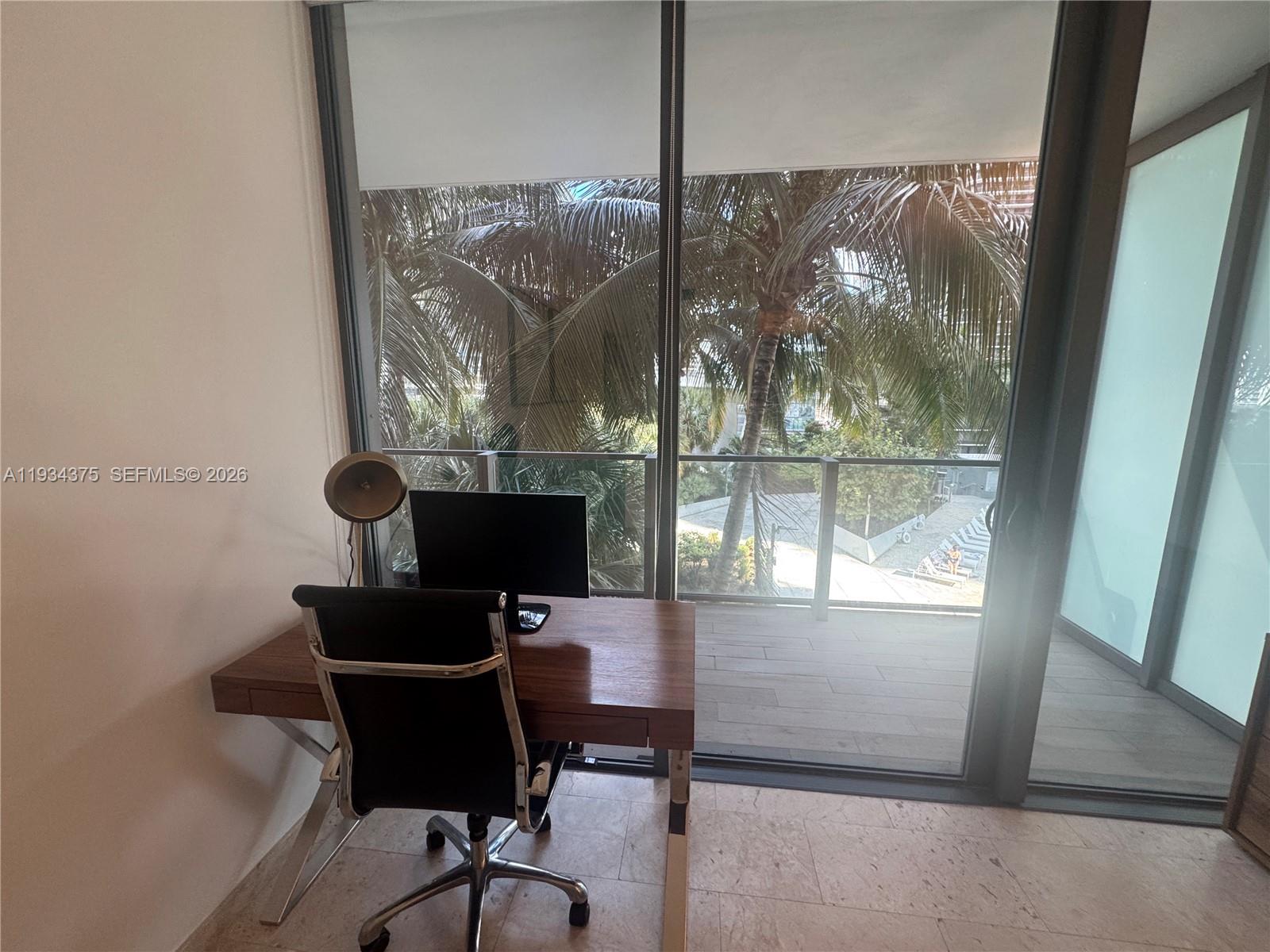 88 Southwest 7th Street, Unit 805 Miami, FL 33130 - Photo 4 of 14 a view of a workspace with furniture and a window