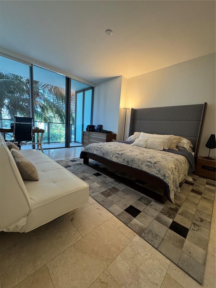88 Southwest 7th Street, Unit 805 Miami, FL 33130 - Photo 5 of 14 a bedroom with a bed and large window