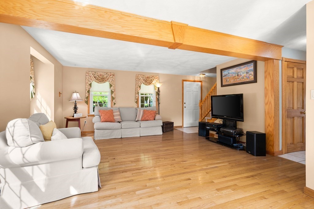 179 Baldwin Road Billerica, MA 01821 - Photo 12 of 38 a living room with furniture and a flat screen tv