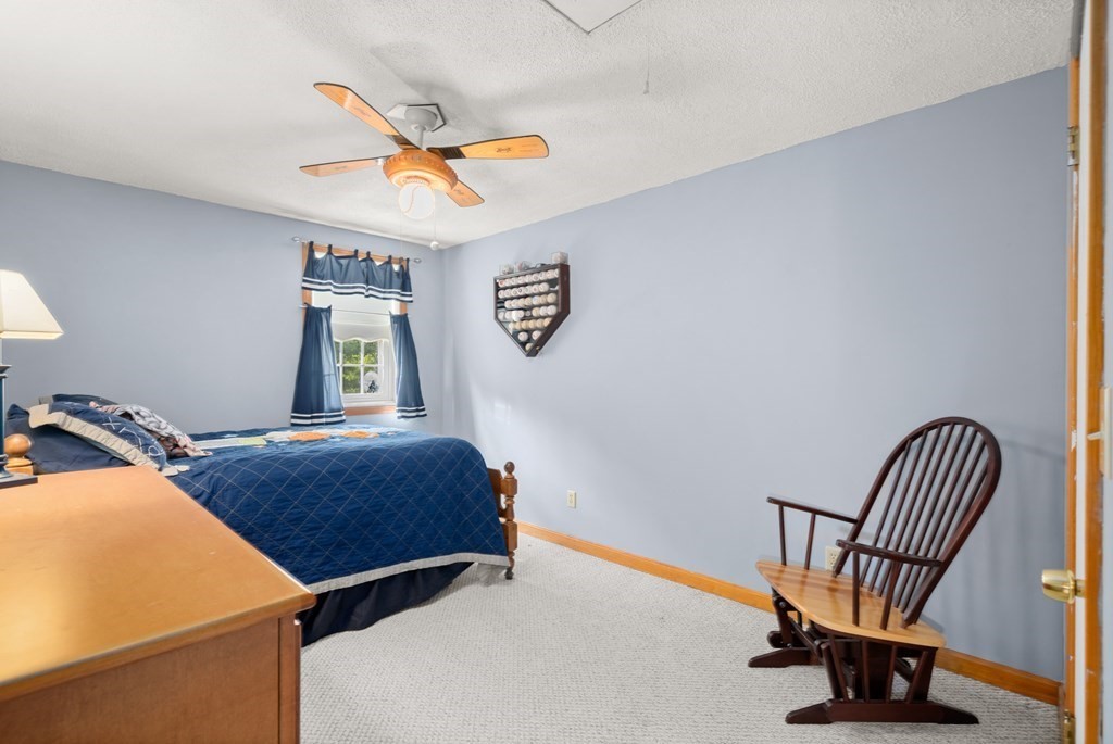 179 Baldwin Road Billerica, MA 01821 - Photo 15 of 38 a bedroom with a bed and a chandelier