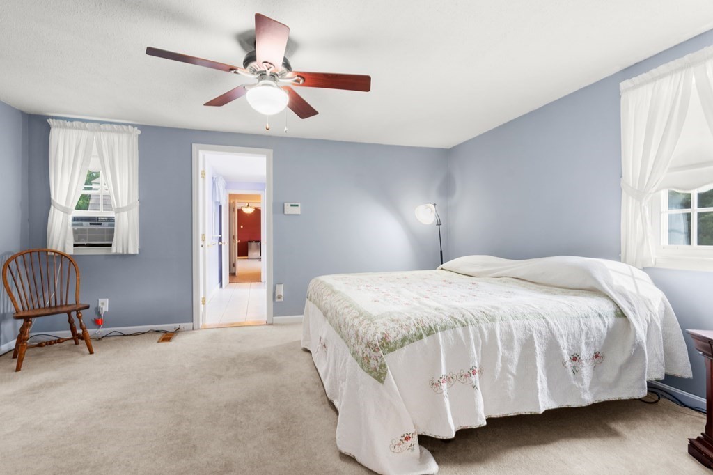 179 Baldwin Road Billerica, MA 01821 - Photo 18 of 38 a bedroom with a bed desk and a window