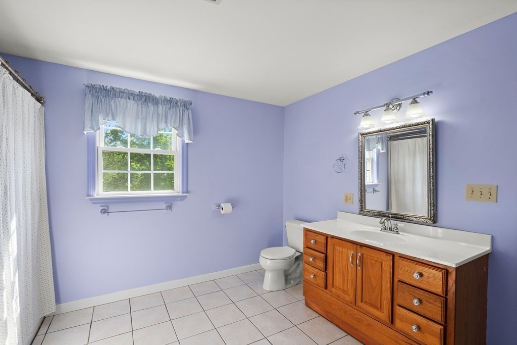 179 Baldwin Road Billerica, MA 01821 - Photo 19 of 38 a bathroom with a sink toilet a mirror and window