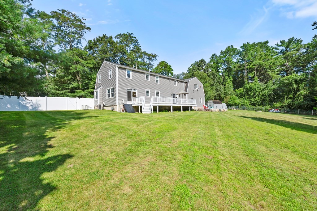 179 Baldwin Road Billerica, MA 01821 - Photo 28 of 38 a white house with a big yard and large trees