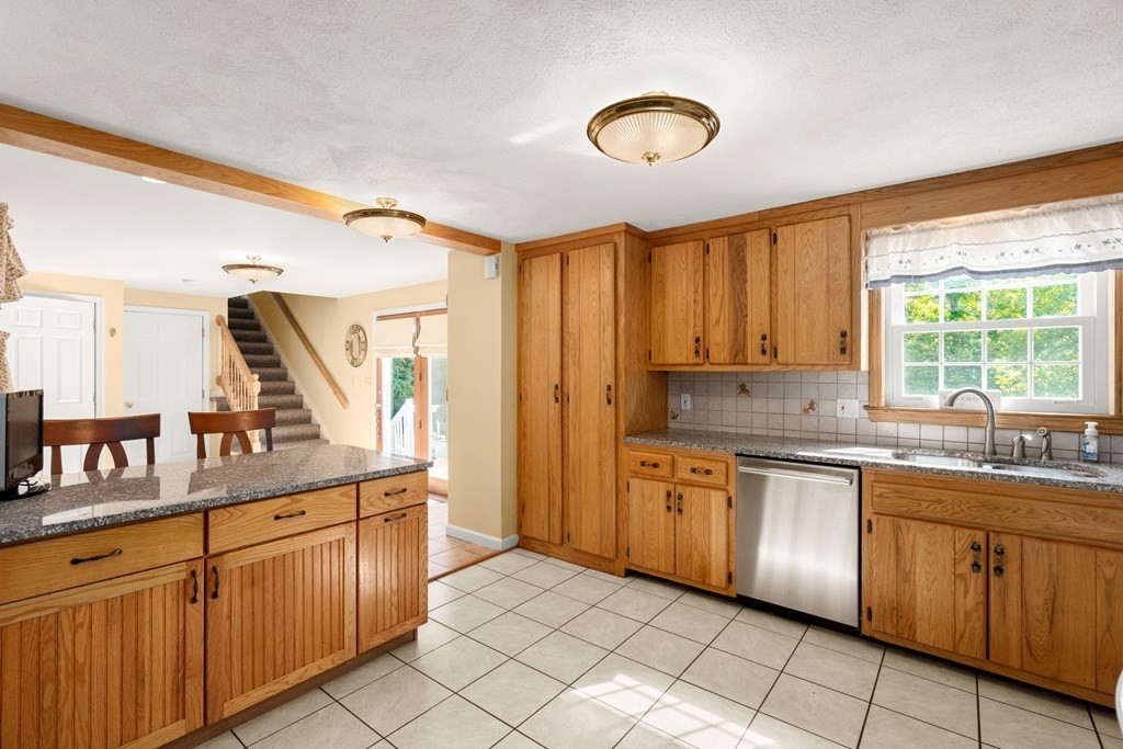 179 Baldwin Road Billerica, MA 01821 - Photo 6 of 38 a kitchen with stainless steel appliances granite countertop a stove a sink and a refrigerator