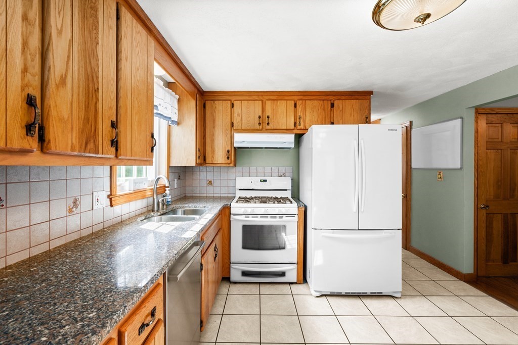 179 Baldwin Road Billerica, MA 01821 - Photo 8 of 38 a kitchen with a white cabinets and white appliances