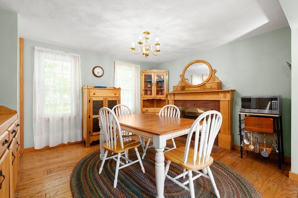 179 Baldwin Road Billerica, MA 01821 - Photo 9 of 38 a view of a dining room with furniture a chandelier and wooden floor