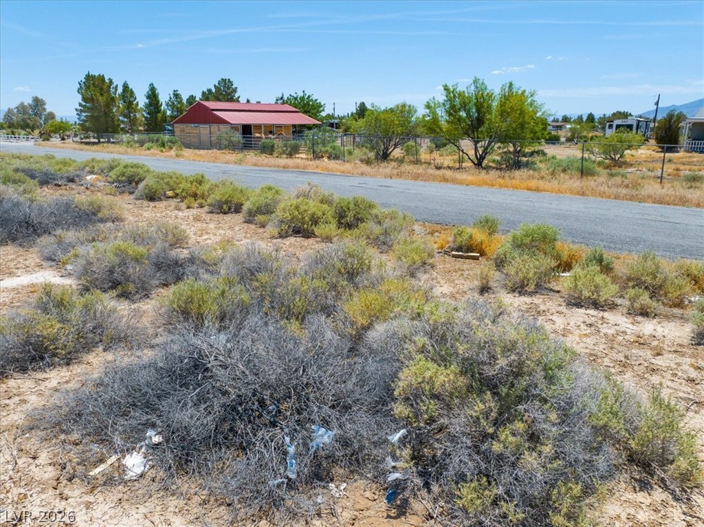 4580 Lawrence Road Pahrump, NV 89048 - Photo 12 of 40 A rural landscape featuring a barn and open fields, offering ample space for various ventures.