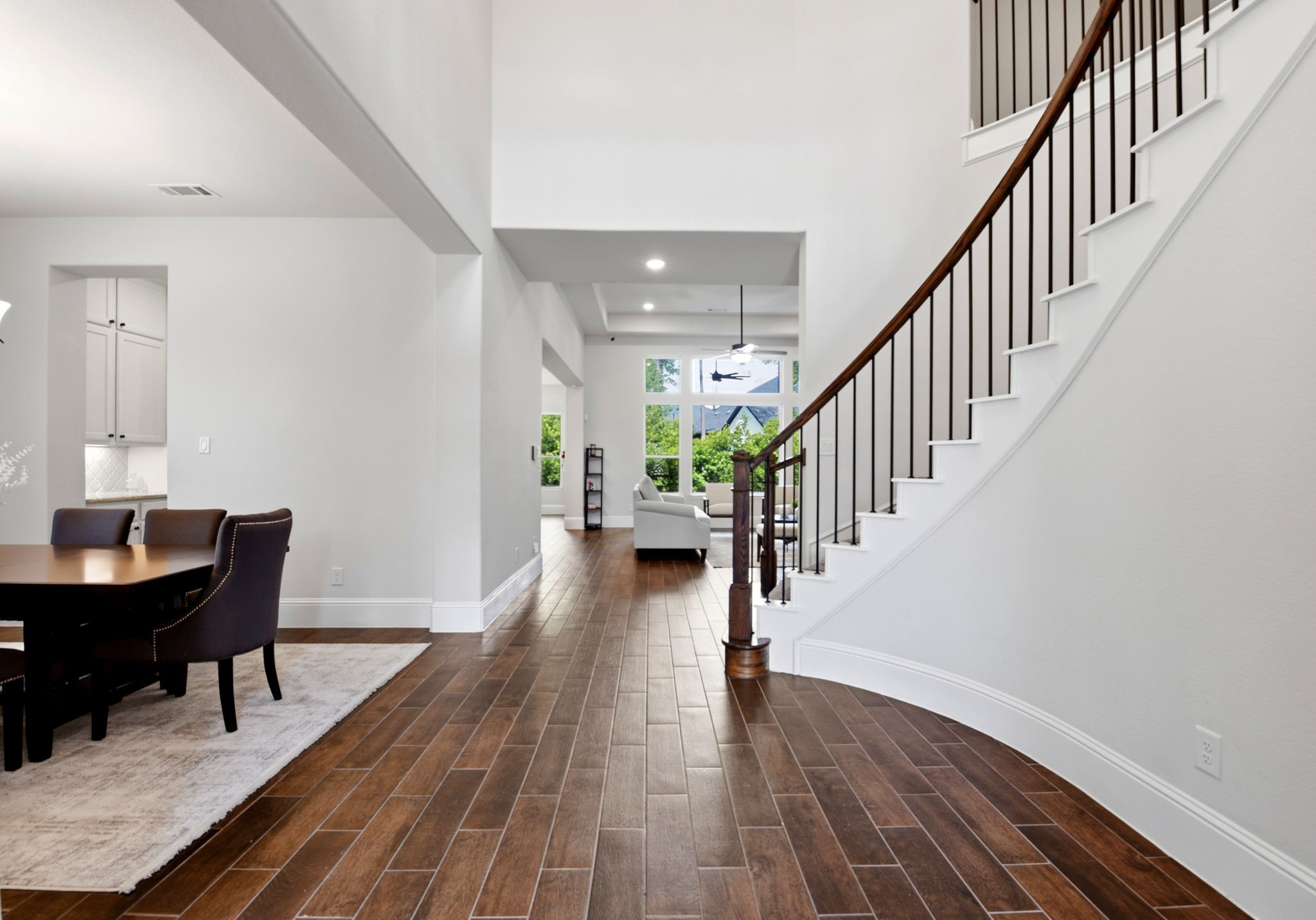 10062 South Goshawk Trail Conroe, TX 77385 - Photo 5 of 43 a view of a hallway with wooden floor table and chairs