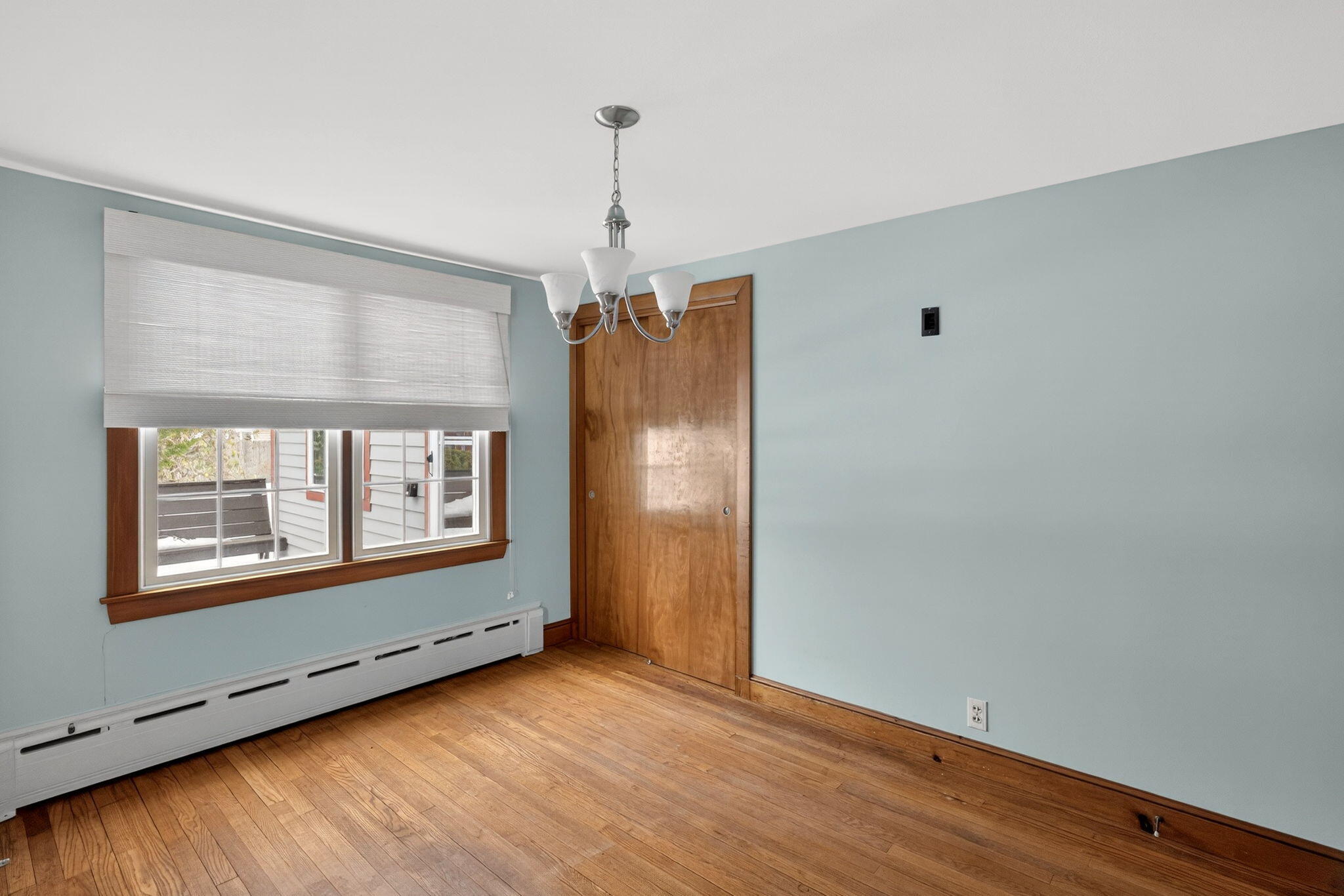 56 Raymond Street Falmouth, MA 02540 - Photo 13 of 45 a view of an empty room with wooden floor and a window