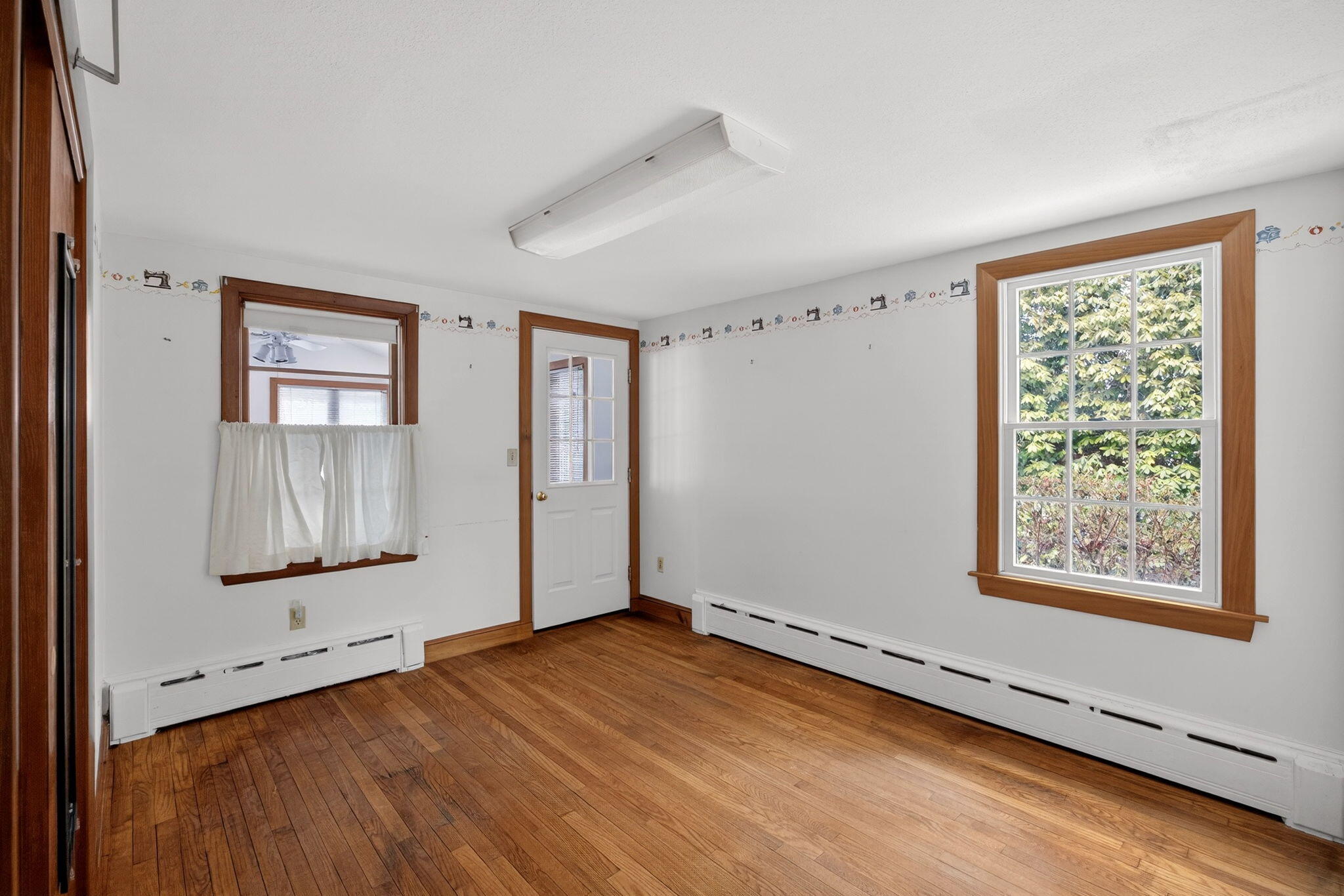 56 Raymond Street Falmouth, MA 02540 - Photo 17 of 45 wooden floor in an empty room with a window