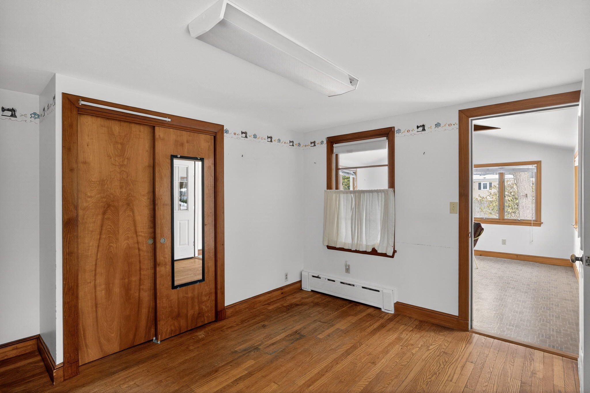 56 Raymond Street Falmouth, MA 02540 - Photo 18 of 45 an empty room with wooden floor and windows