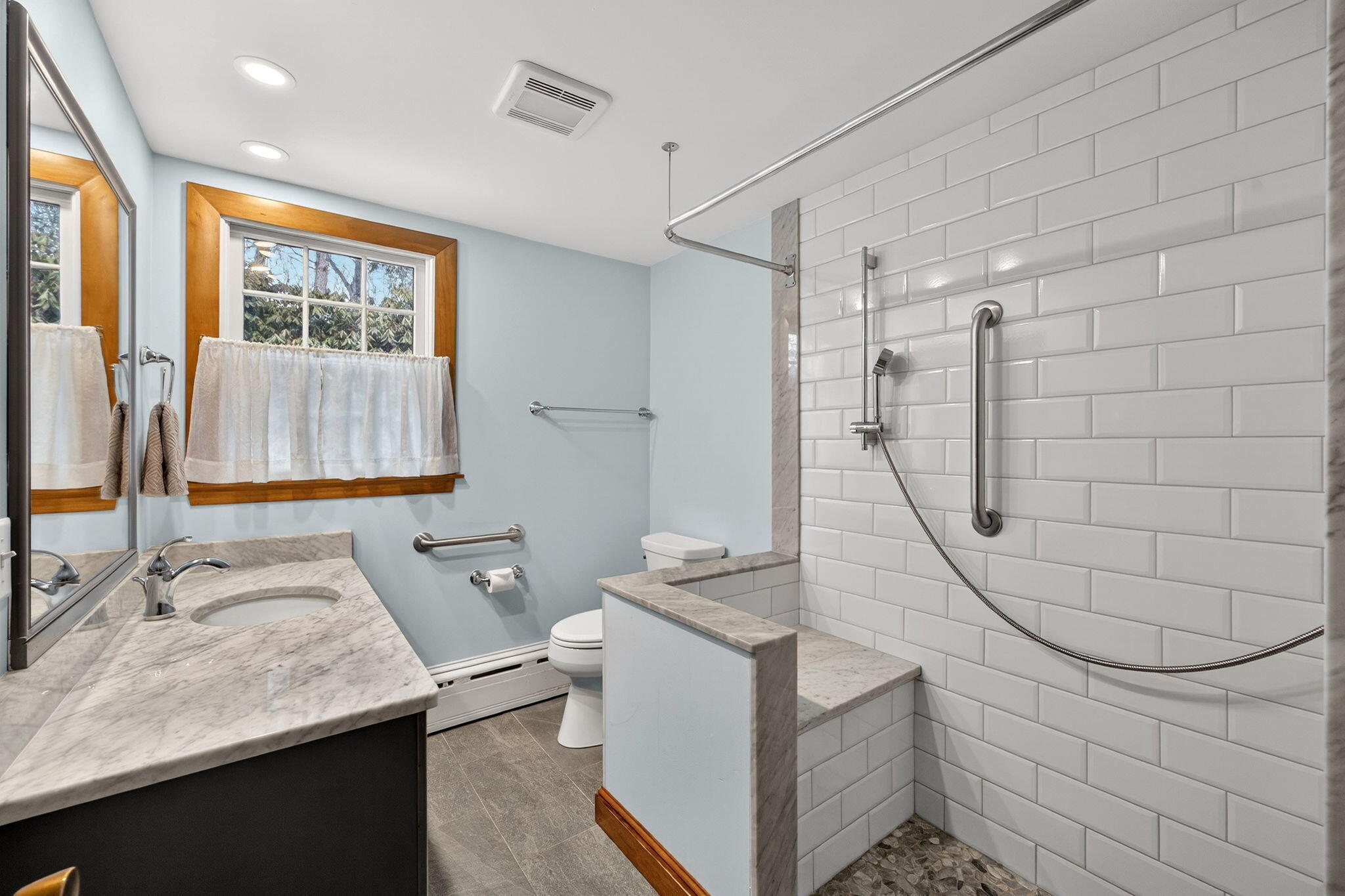 56 Raymond Street Falmouth, MA 02540 - Photo 22 of 45 a bathroom with a sink a vanity and mirror