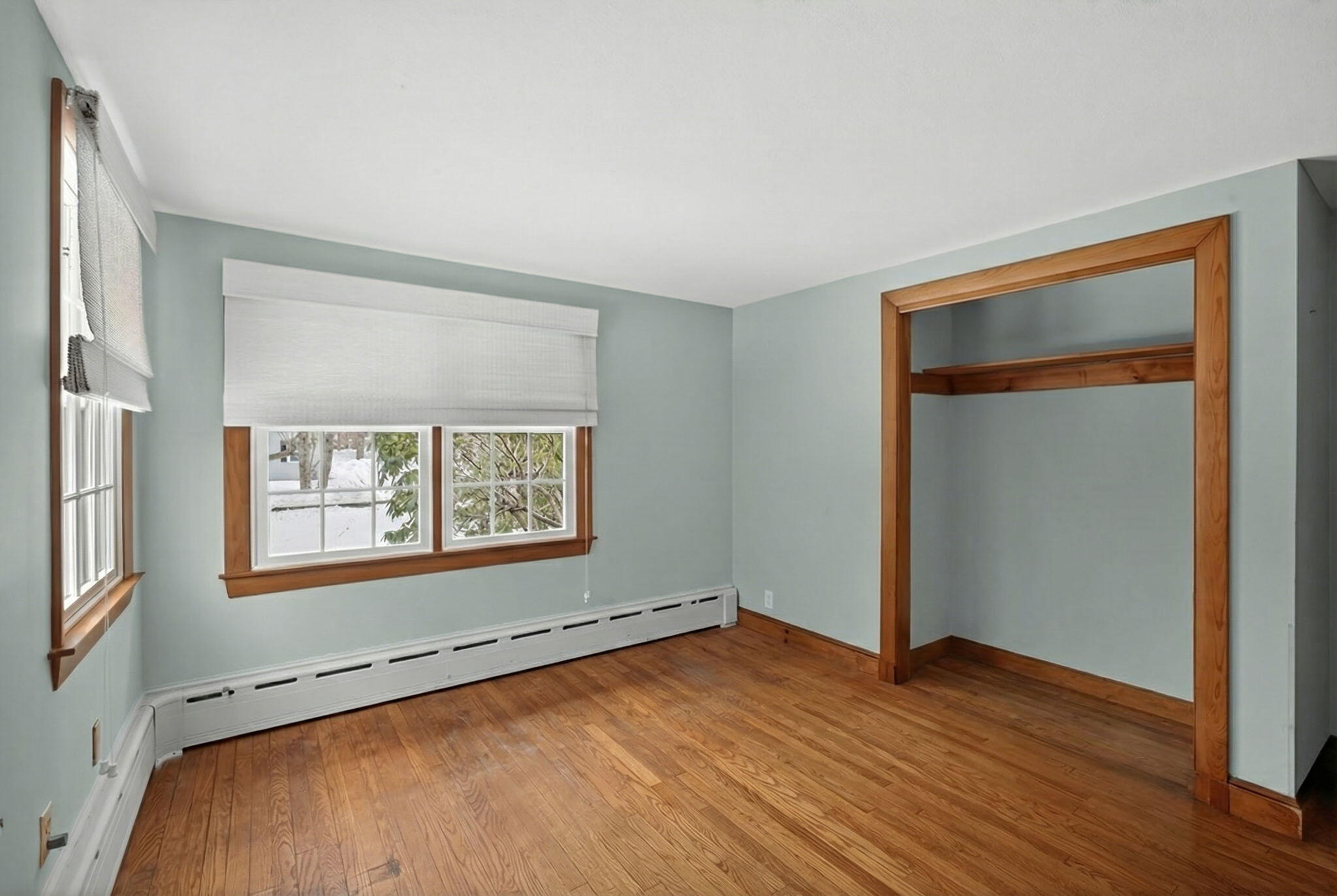 56 Raymond Street Falmouth, MA 02540 - Photo 26 of 45 a view of an empty room with wooden floor and a window