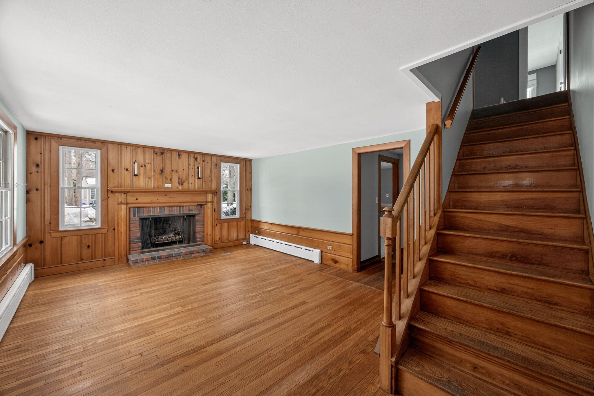 56 Raymond Street Falmouth, MA 02540 - Photo 27 of 45 a view of an empty room with wooden floor fireplace and a window