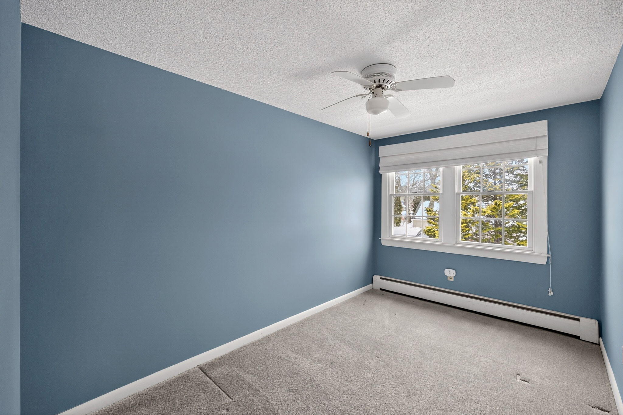 56 Raymond Street Falmouth, MA 02540 - Photo 30 of 45 an empty room with a window and a ceiling fan