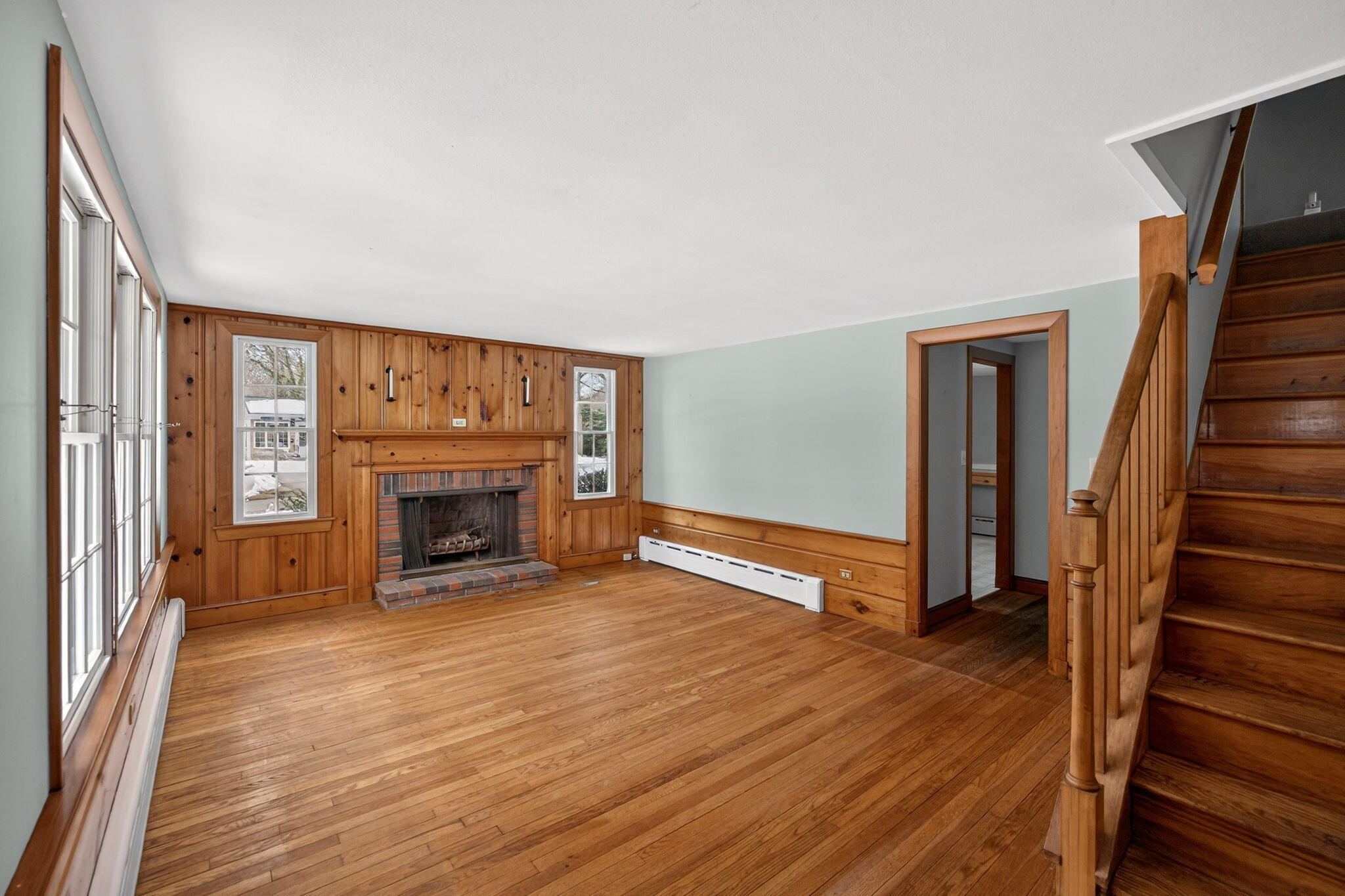 56 Raymond Street Falmouth, MA 02540 - Photo 3 of 45 a view of an empty room with wooden floor fireplace and a window