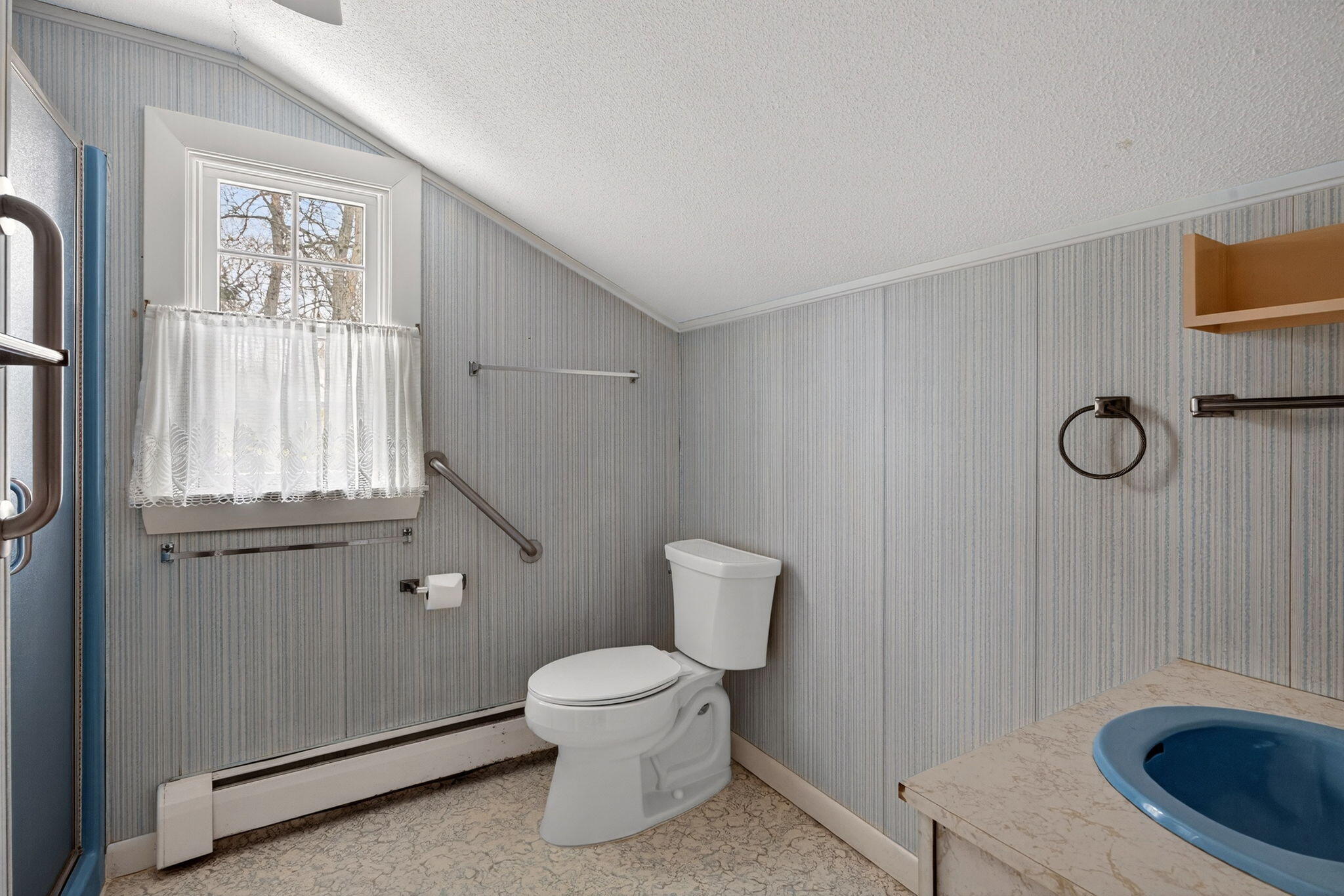 56 Raymond Street Falmouth, MA 02540 - Photo 33 of 45 a white toilet sitting next to a bathroom sink and vanity