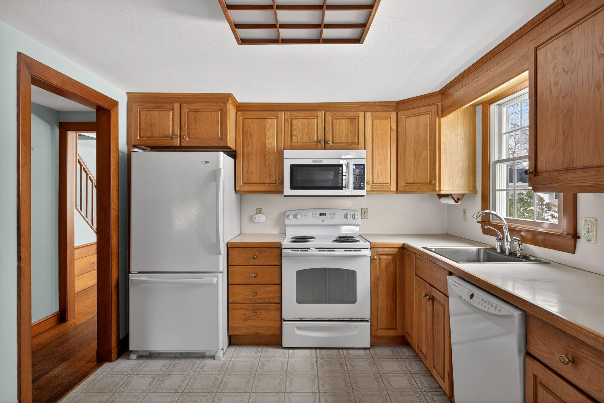 56 Raymond Street Falmouth, MA 02540 - Photo 4 of 45 a kitchen with a refrigerator sink and microwave