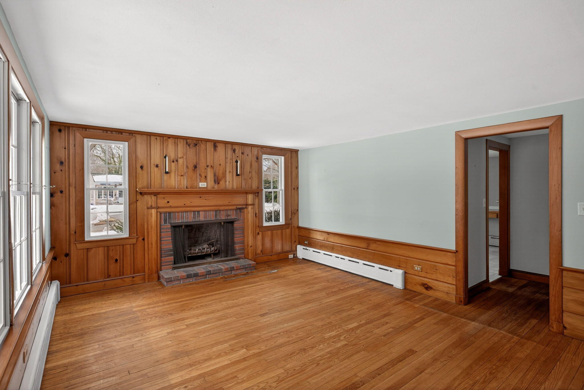 56 Raymond Street Falmouth, MA 02540 - Photo 6 of 45 wooden floor fireplace and windows in an empty room
