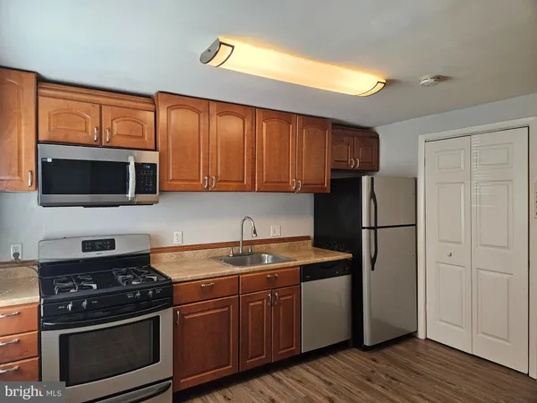 a kitchen with a sink stove and microwave
