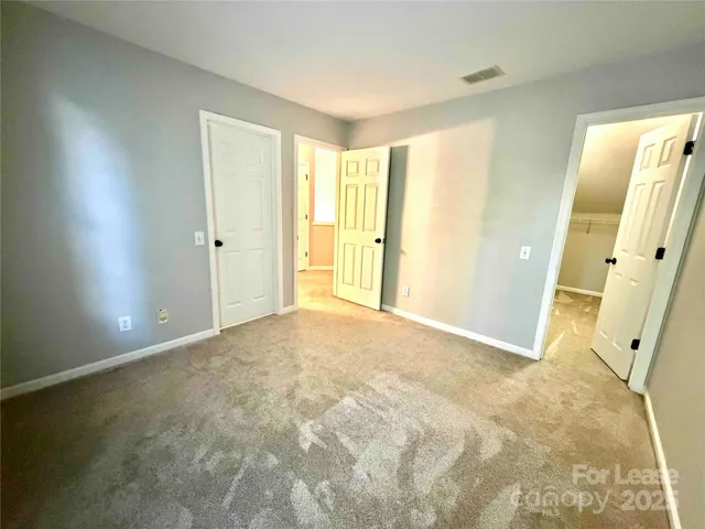 a view of a big room with windows and refrigerator