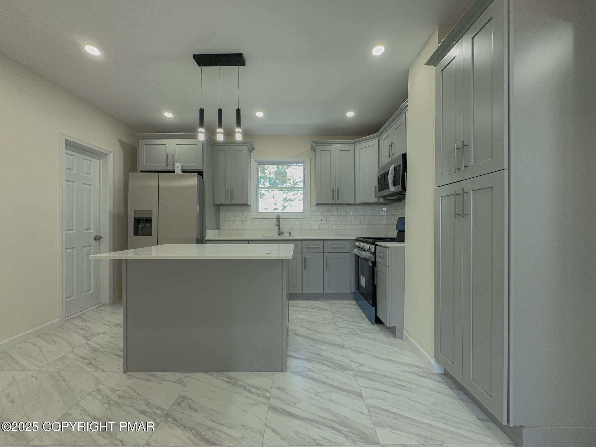 1240 Main Street Pittston, PA 18640 - Photo 11 of 24 a kitchen with kitchen island a counter top space stainless steel appliances and cabinets