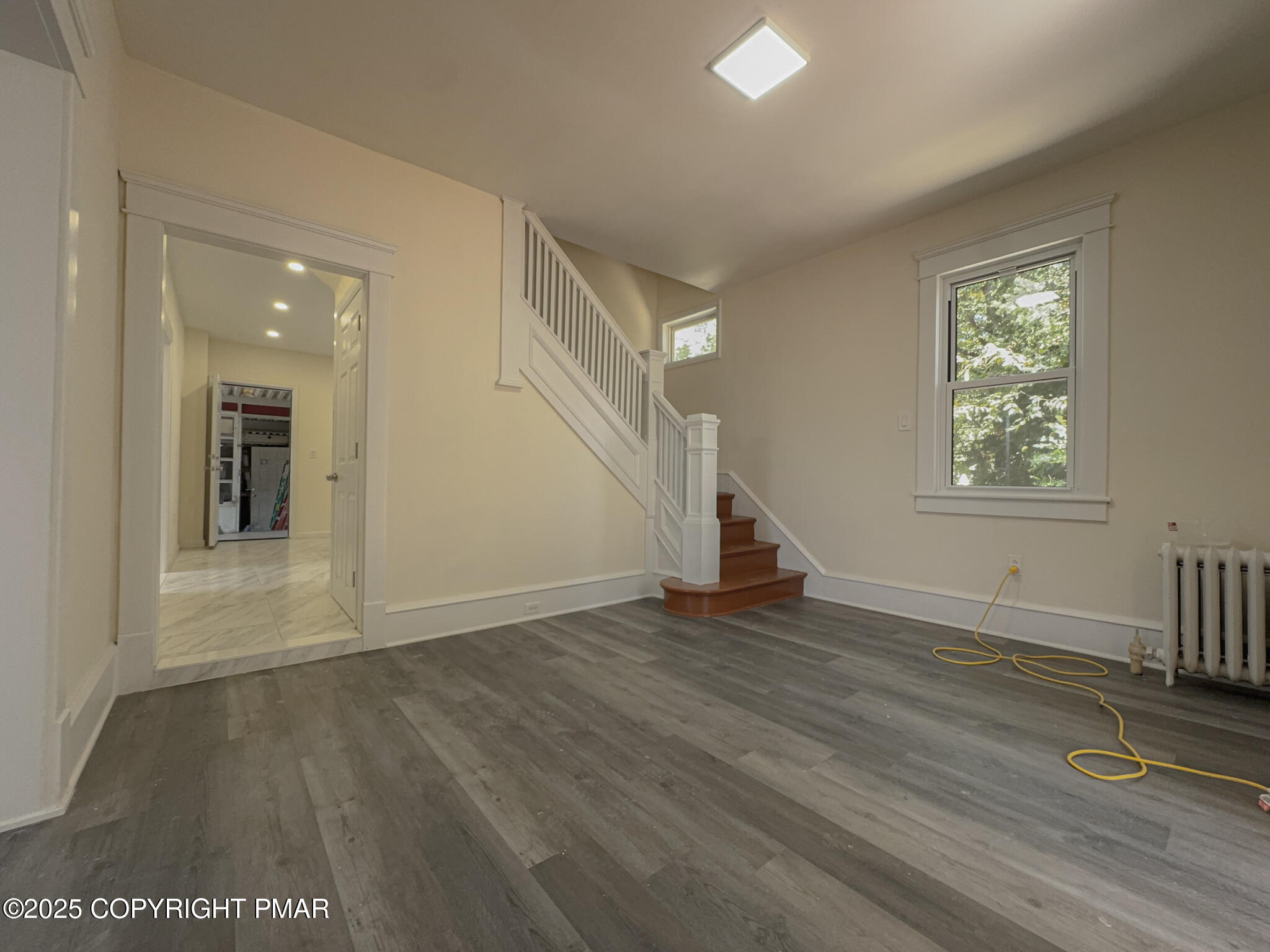 1240 Main Street Pittston, PA 18640 - Photo 4 of 24 an empty room with wooden floor and windows