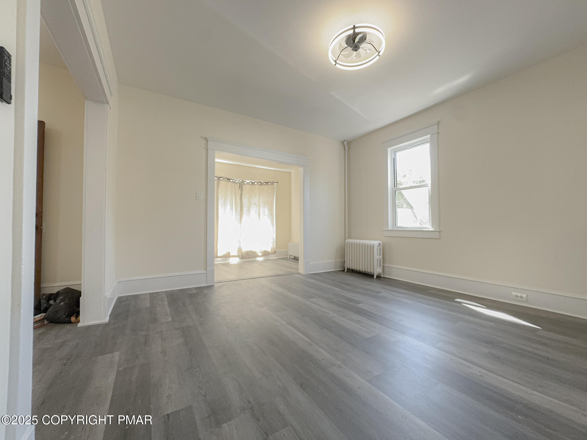 1240 Main Street Pittston, PA 18640 - Photo 8 of 24 an empty room with wooden floor and window