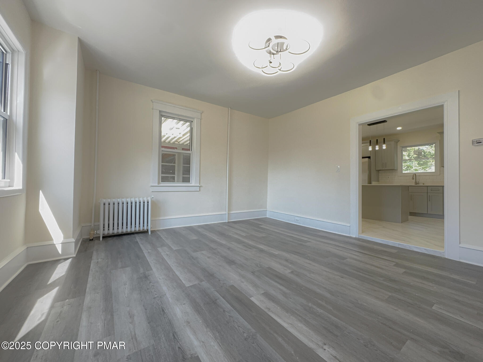 1240 Main Street Pittston, PA 18640 - Photo 9 of 24 an empty room with wooden floor and windows