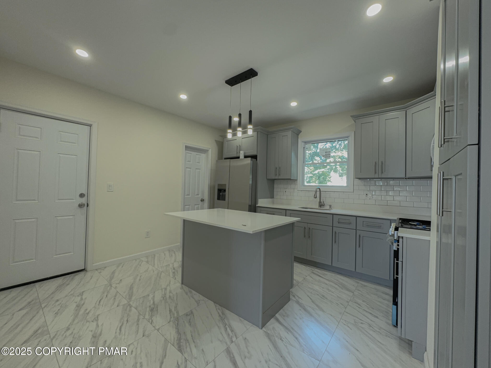 1240 Main Street Pittston, PA 18640 - Photo 10 of 24 a kitchen with kitchen island a sink stainless steel appliances and cabinets