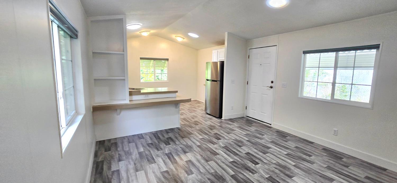 226 Full Circle Davis, CA 95618 - Photo 12 of 27 a view of an empty room with wooden floor and a window