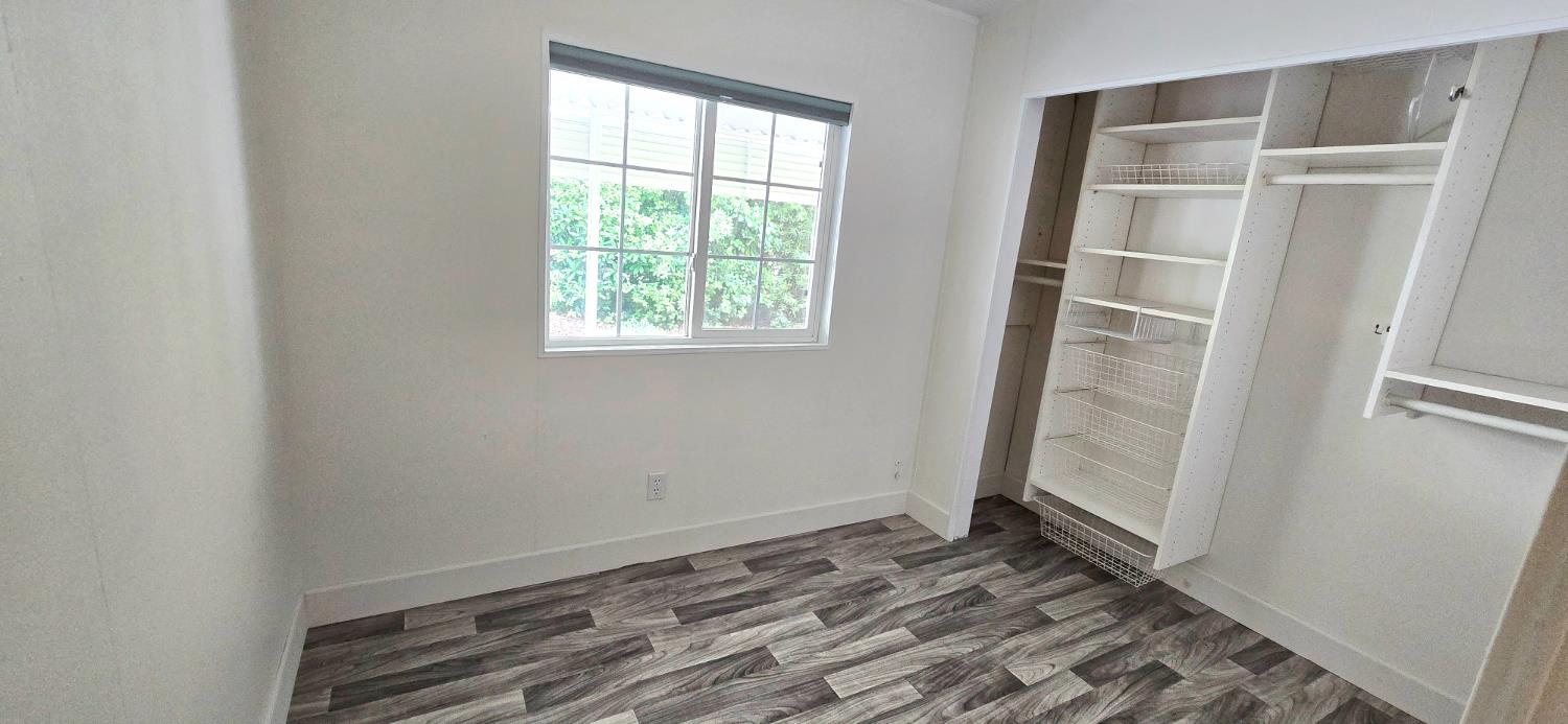 226 Full Circle Davis, CA 95618 - Photo 13 of 27 an empty room with wooden floor and entrance