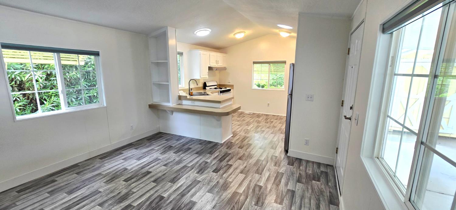 226 Full Circle Davis, CA 95618 - Photo 3 of 27 a view of kitchen with wooden floor and electronic appliances