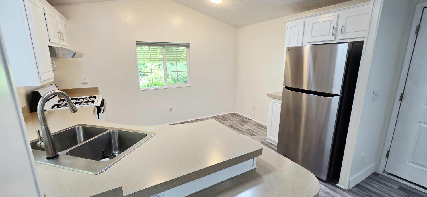 226 Full Circle Davis, CA 95618 - Photo 5 of 27 a view of a kitchen with refrigerator and window
