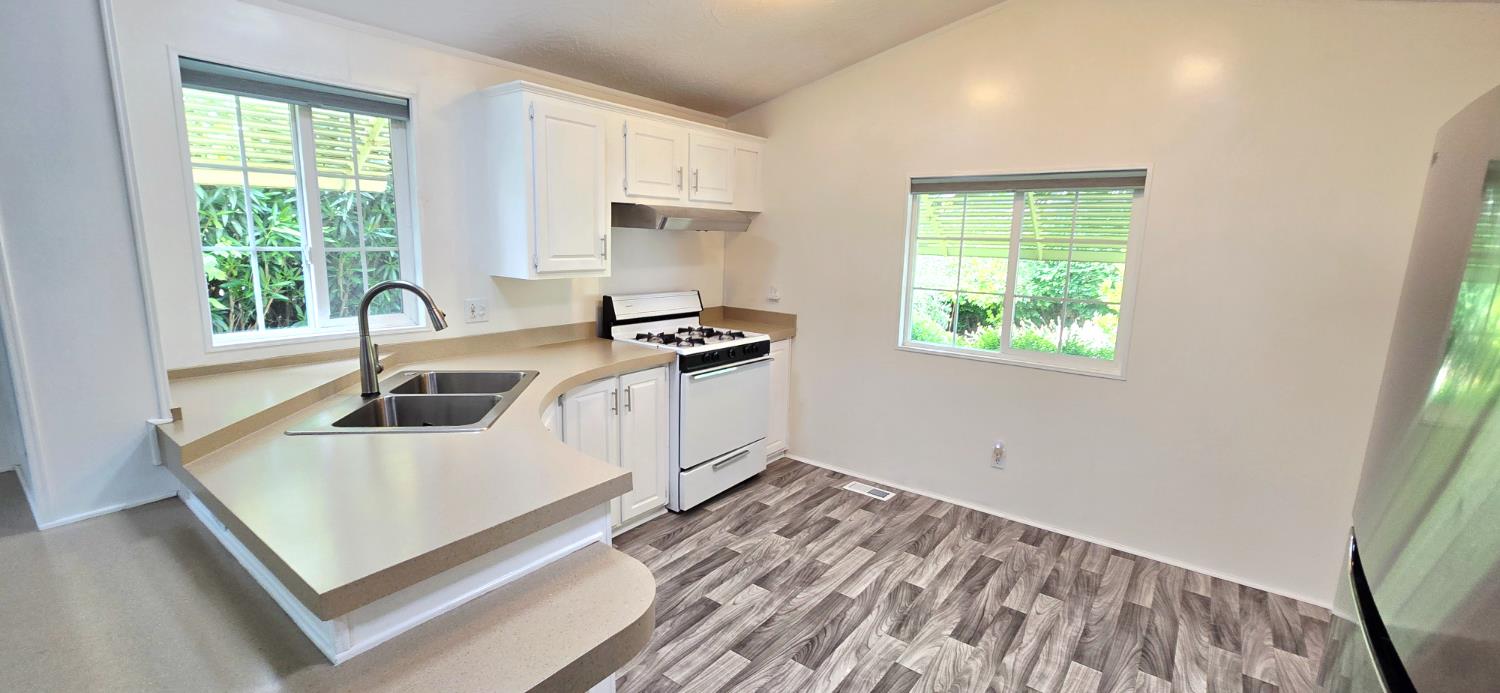 226 Full Circle Davis, CA 95618 - Photo 6 of 27 a kitchen that has a sink a stove and a window
