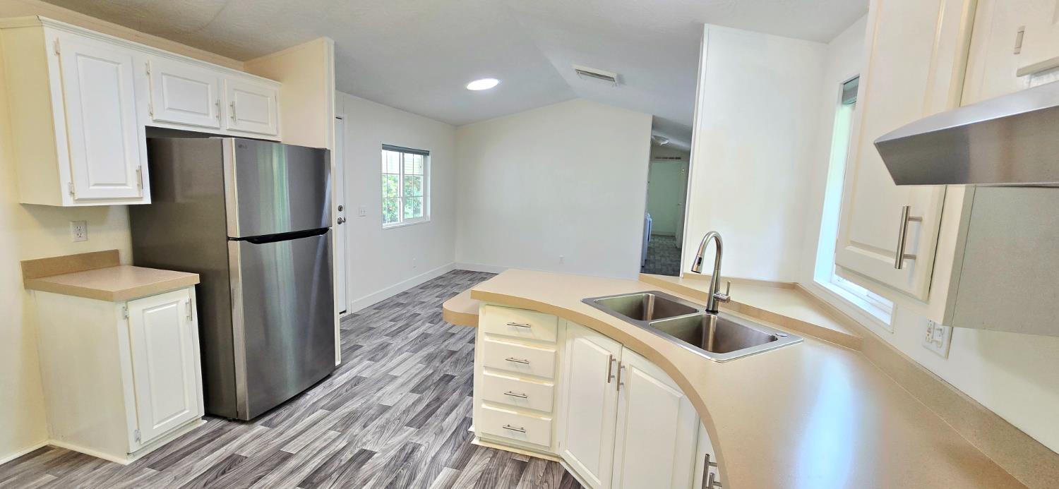 226 Full Circle Davis, CA 95618 - Photo 7 of 27 a kitchen with a refrigerator sink and cabinets