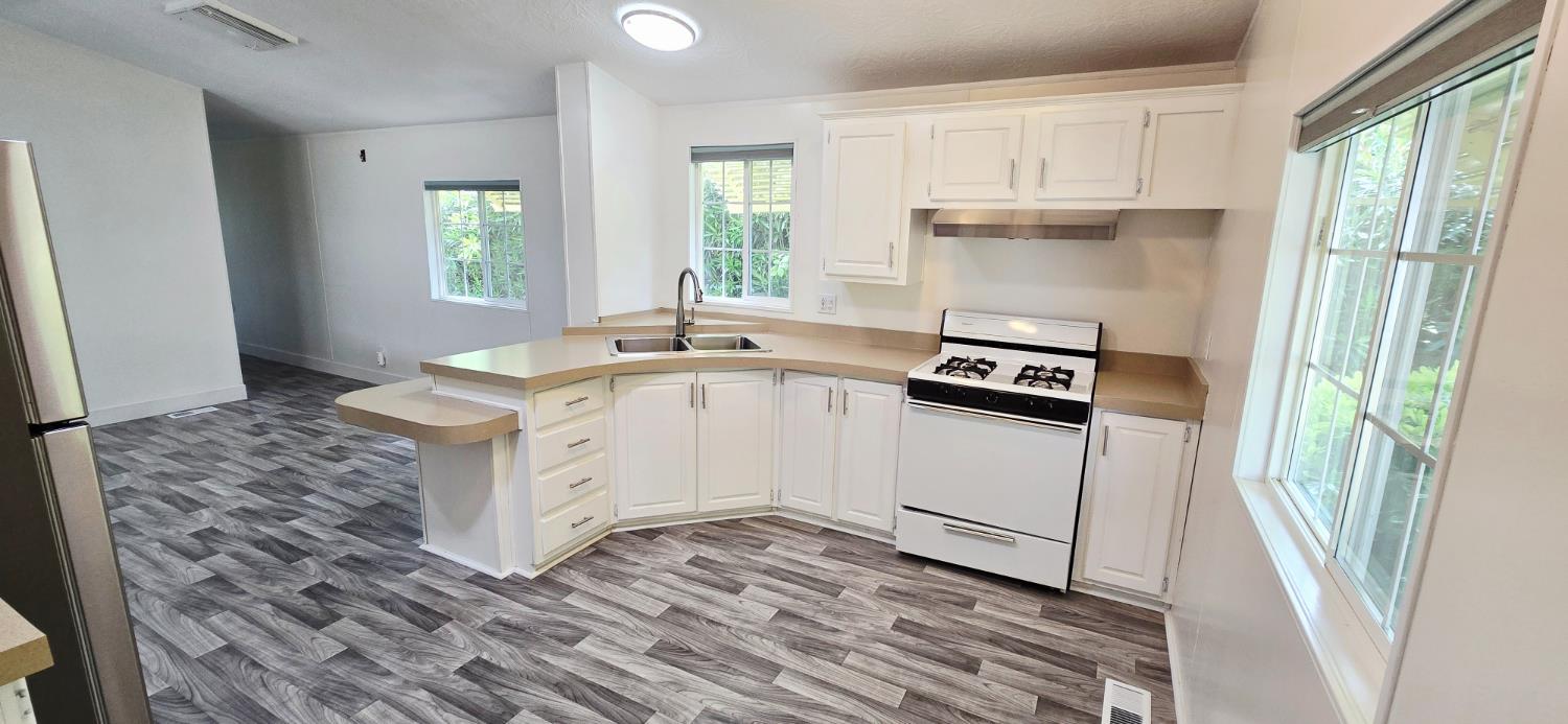 226 Full Circle Davis, CA 95618 - Photo 8 of 27 a kitchen with a sink stove and cabinets