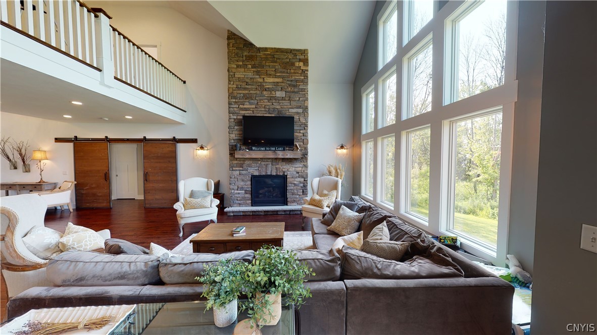 8861 Shellman Drive Cicero, NY 13039 - Photo 15 of 50 A gas fireplace and floor to ceiling windows help